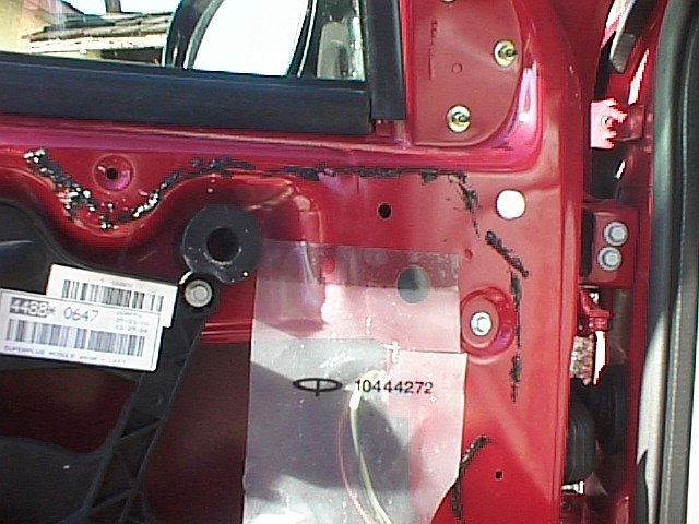 Picture of driver side door with trim panel removed. Shows 2 mirror mounting bolts.